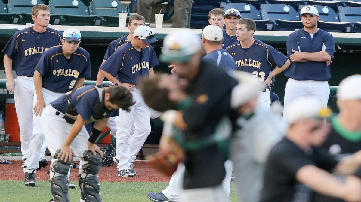 
A defeated O'Fallon baseball team exits the dugout as Providence Catholic celebrates their Class 4A super-sectional victory.

