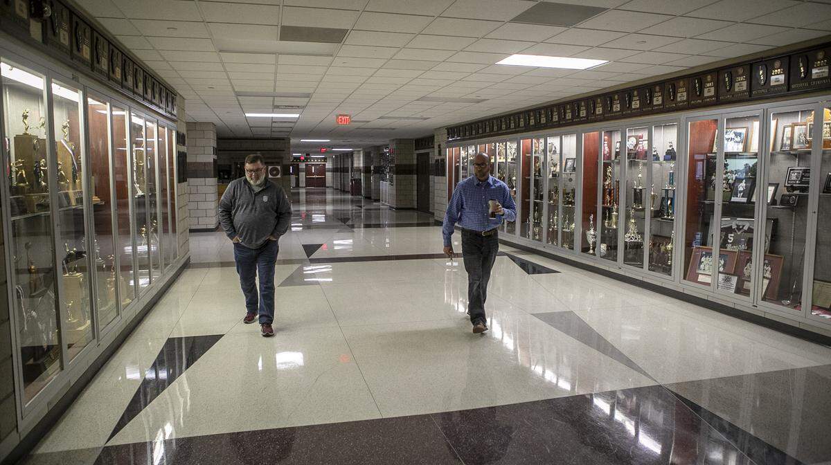 Belleville Township High School District 201 Superintendent Jeff Dosier, left, and Assistant Superintendent Brian Mentzer walk through the empty halls of Belleville West High School. Students are taking online classes due to the coronavirus pandemic.