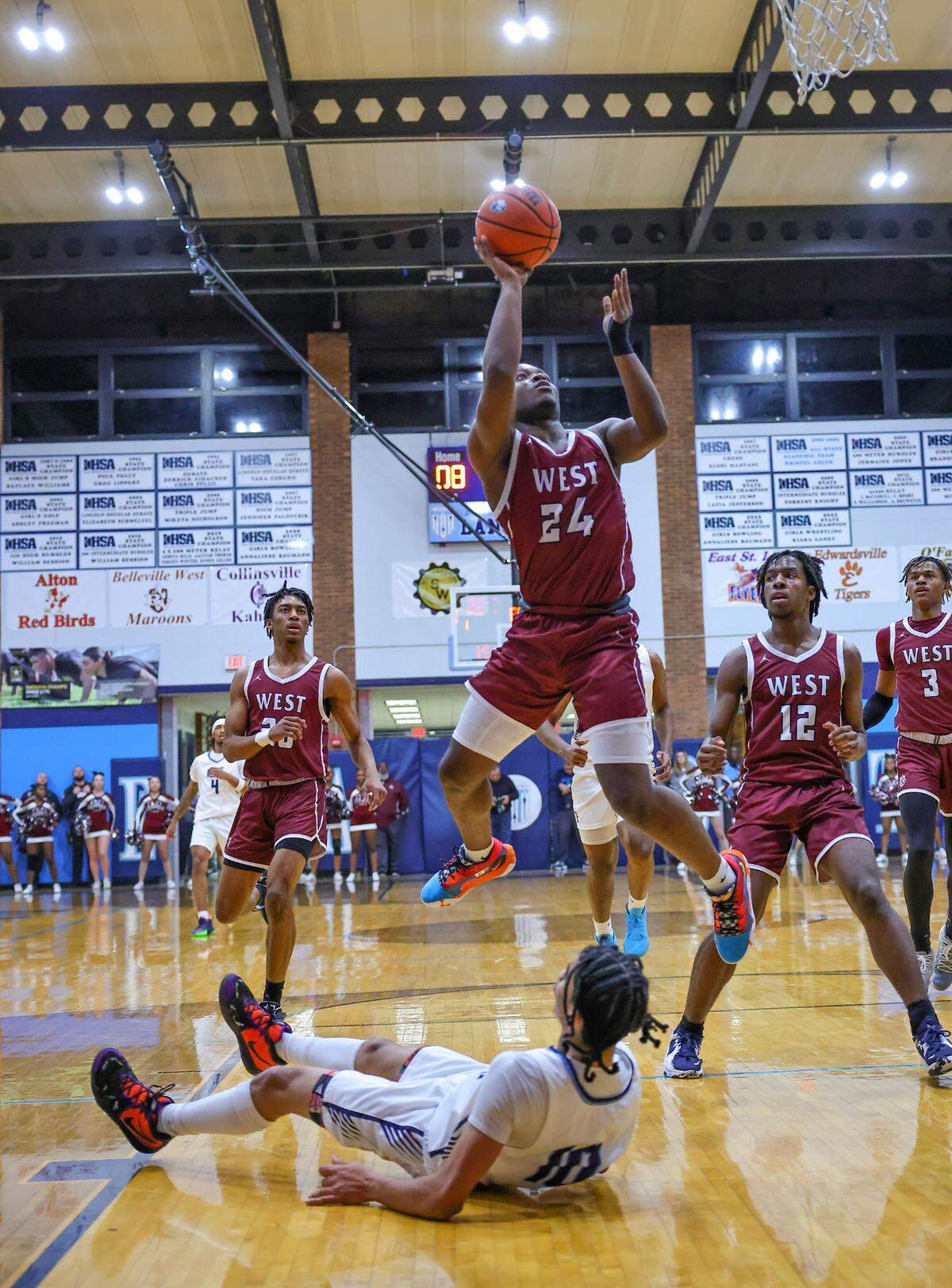 Belleville West’s Daylen Byrd drives to the basket during Friday night’s Southwestern Conference game against Belleville East. The Maroons ultimately lost 66-57.