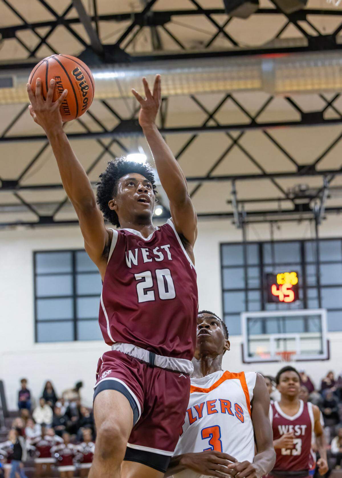 Belleville West’s David Marshall Jr. goes to the basket during Friday night’s Southwestern Conference game against East St. Louis. The Maroons ultimately fell to the Flyers 81-52.