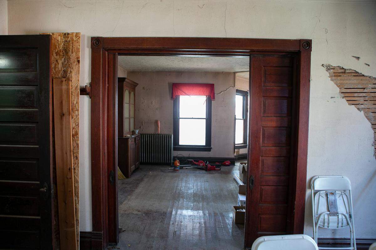 Massive pocket doors separate the parlor from the dining room of “The Pink House” in Aviston. The Kuhl family, which bought the home in December, plans to convert the dining room into a kitchen.