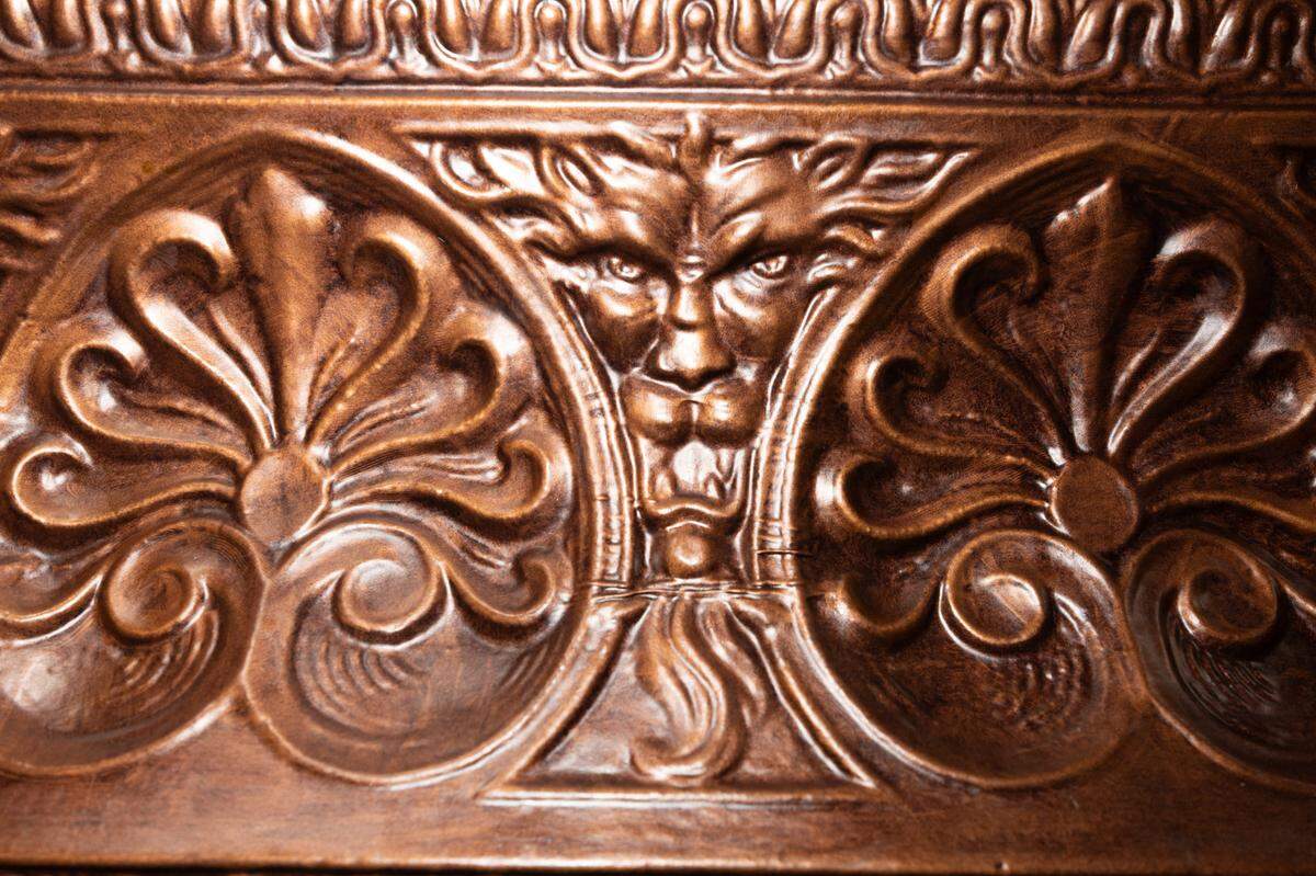 The wooden beams in the bar room feature hand-carved motifs of gods and lions.