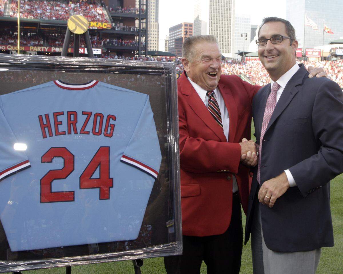 St. Louis Cardinals former manager hall-of-famer Whitey Herzog shares a laugh with team general manager John Mozeliak during a ceremony to retire his number before a baseball game between the Pittsburgh Pirates and the St. Louis Cardinals, Saturday, July 31, 2010.