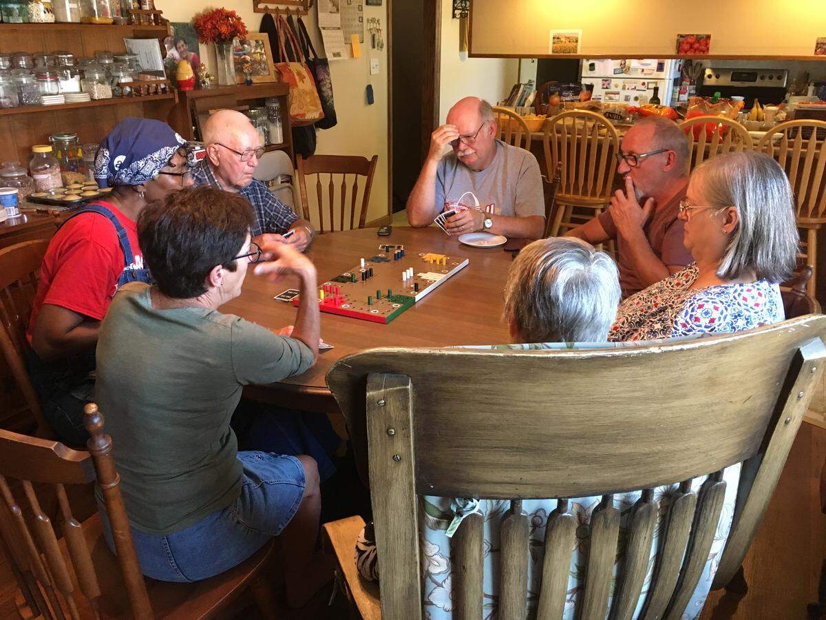 Mary Wilson’s family plays a French game called Tak-Tik with her French pen pal, Annie Almoguera, second from left, and Annie’s friend, Georges Charbonnel, second from right.