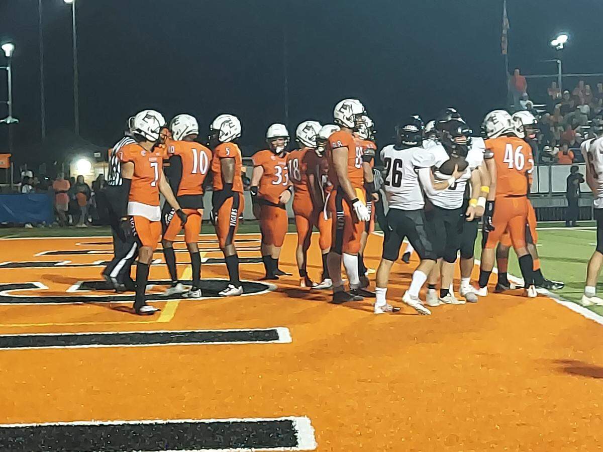 Highland running back Travis Porter celebrates a touchdown run late in the second quarter against Edwardsville during a non-conference road game at the District 7 Athletic Complex in Edwardsville. The Tigers ultimately defeated the Bulldogs 31-28.