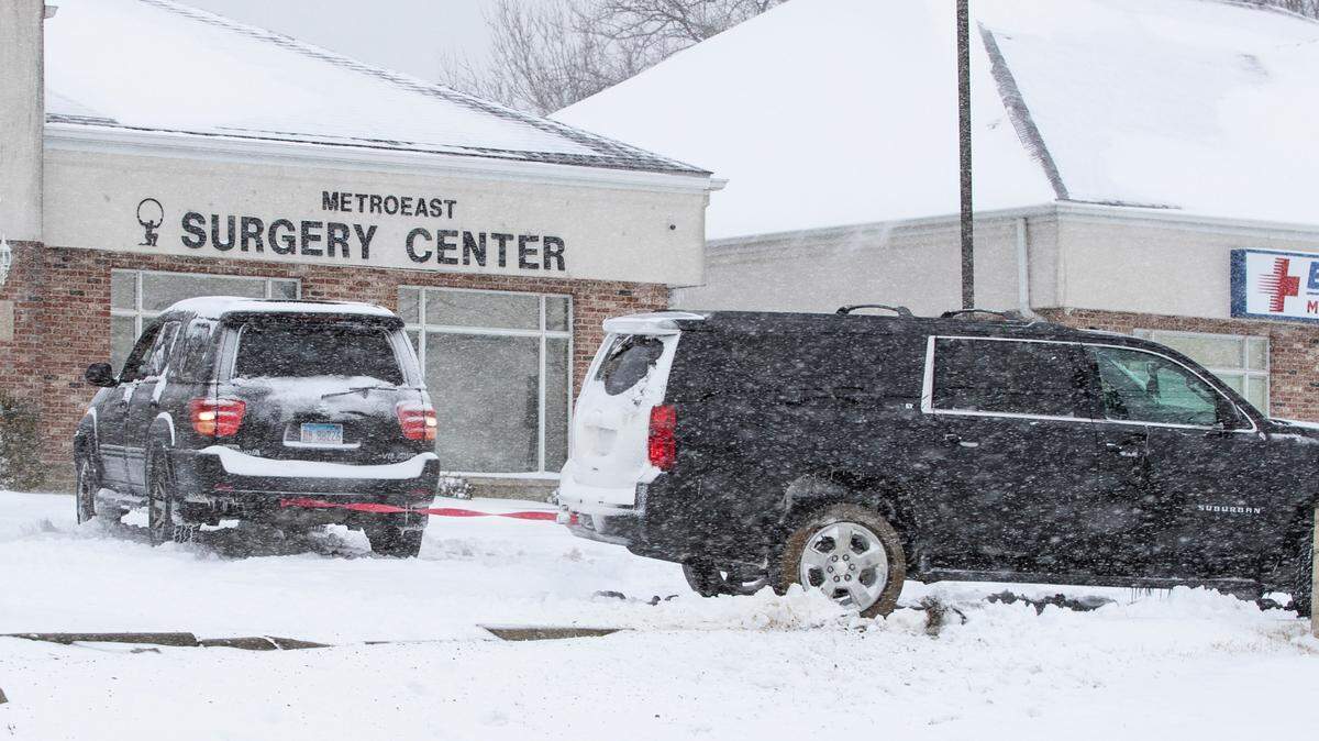 The Toyota on the left helps get the Suburban unstuck from a medical office parking lot in Fairview Heights. A layer of ice under the snow was giving many drivers problems Thursday morning.
