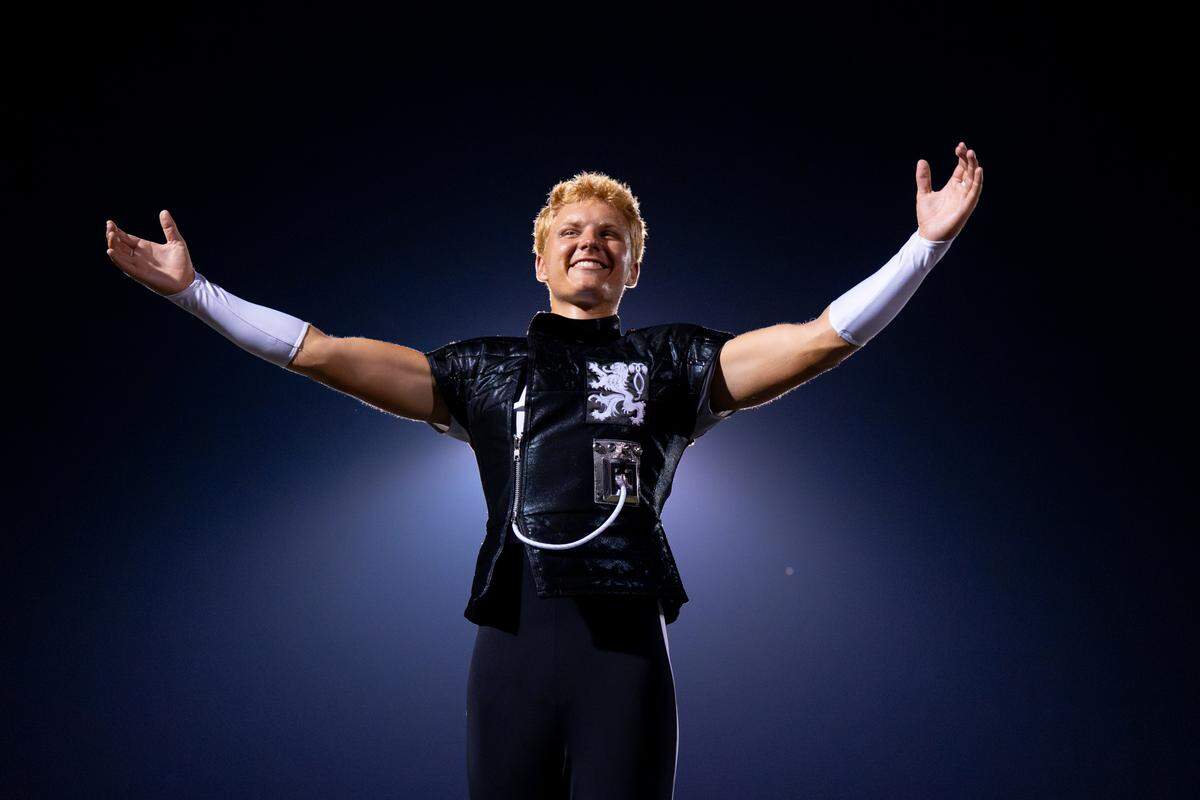 The Boston Crusaders drum major Wes Booker thanks the crowd after the drum corps performs their show “BOOM” at Belleville West High School on Tuesday, July 22, 2025, in Belleville.