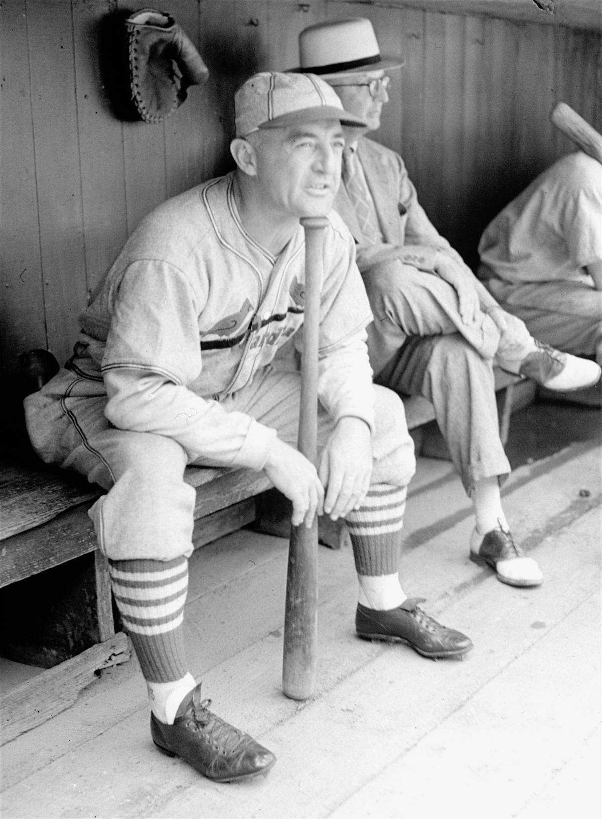 Frankie Frisch, manager of the St. Louis Cardinals is feeling pretty glum these days as his charges continue to stay way down in the standings on July 26, 1937. Although a bench manager, Frankie still holds a bat as he sits in the dugout, wondering how to stretch his faltering pitching staff through the season.  (AP Photo)
