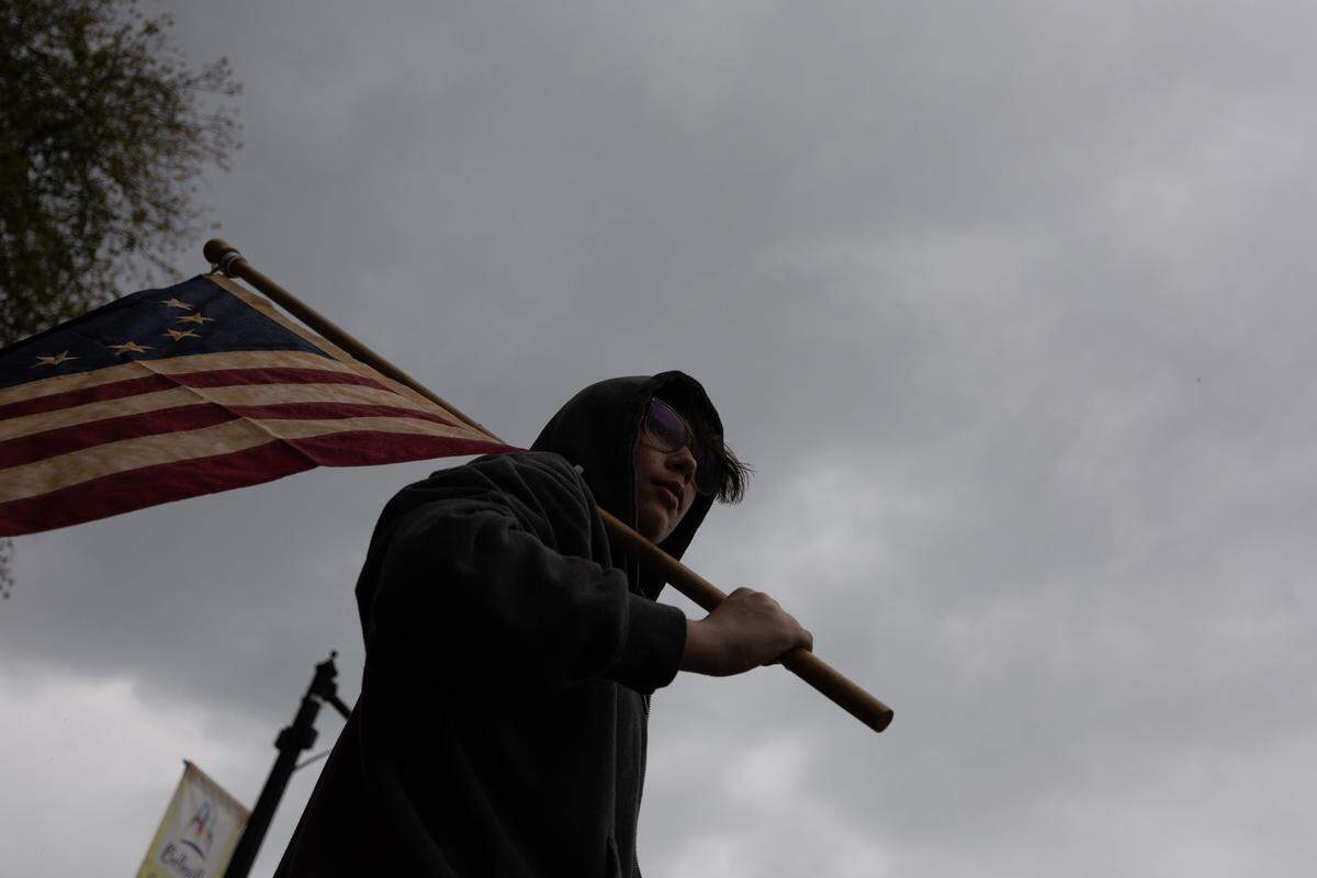 A protester holds up a flag during the No Kings protest on the Belleville Public Square on Saturday.