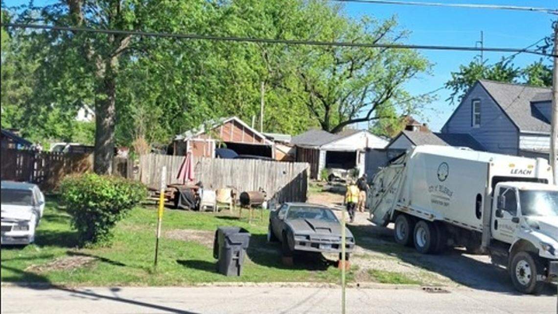 City of Belleville sanitation workers fill a trash truck on Wednesday with items from properties on South 19th Street owned by George Green. A judge had ordered him to clean them up.