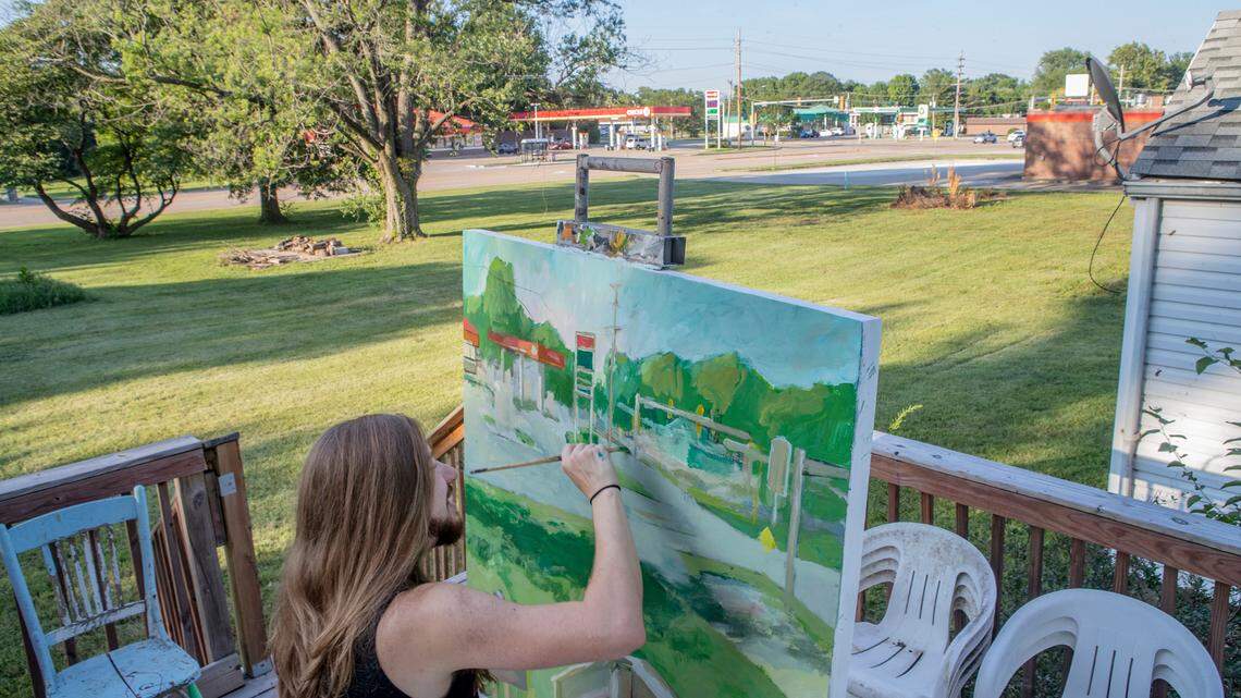 Silas Coggeshall paints the Circle K gas station from the deck of his home on Old Lincoln Trail in Fairview Heights. He’s one of two artists-in-residence with a nonprofit organization called Art Village.