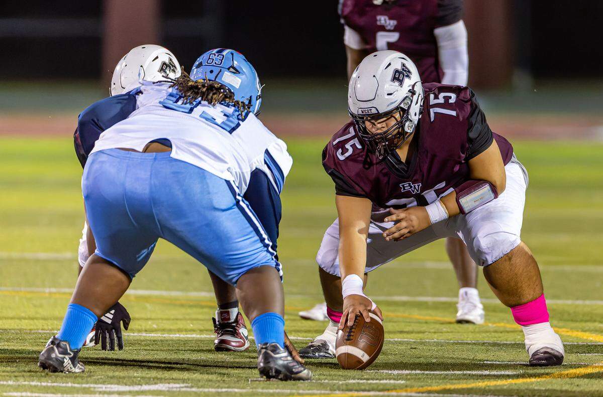 October 17, 2025 - Belleville, IL - Belleville West center Mike Bell prepare to snap the ball during a game between the Belleville West Maroons and the Belleville East Lancers on October 17th at Belleville West.  [Photo: Jimmy Simmons]