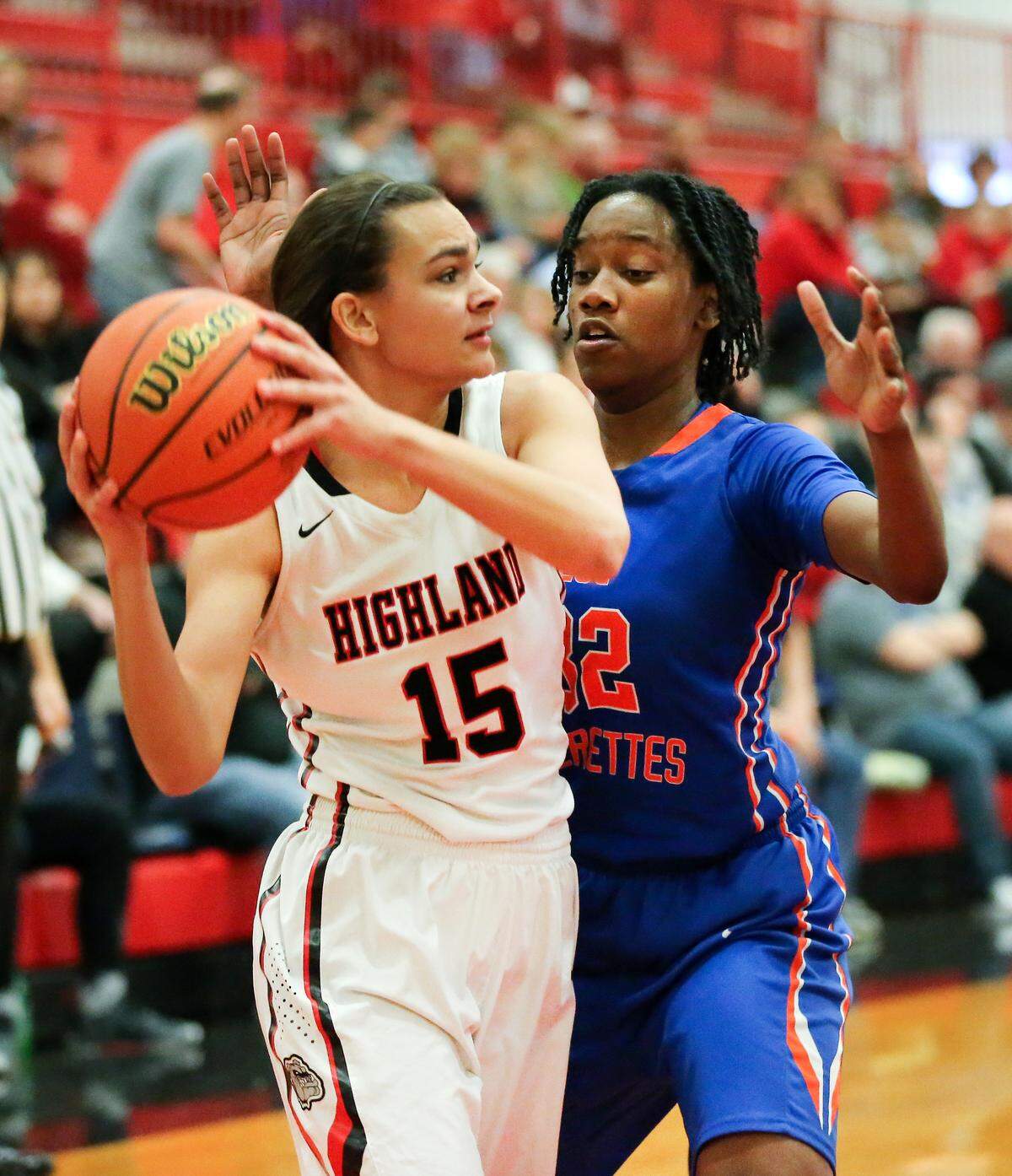 Highland Megan Kronk post up against Mya Glanton during the Highland Scott Credit Union/Optimists Shootout Saturday.