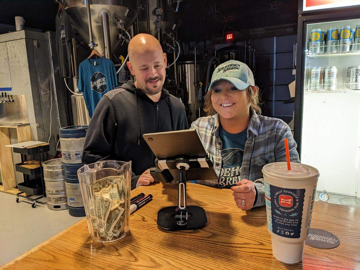 Shoehorn Brewing co-owner Jeremy Hall and brewer Corina Mager during the microbrewery’s soft opening event in December 2022.
