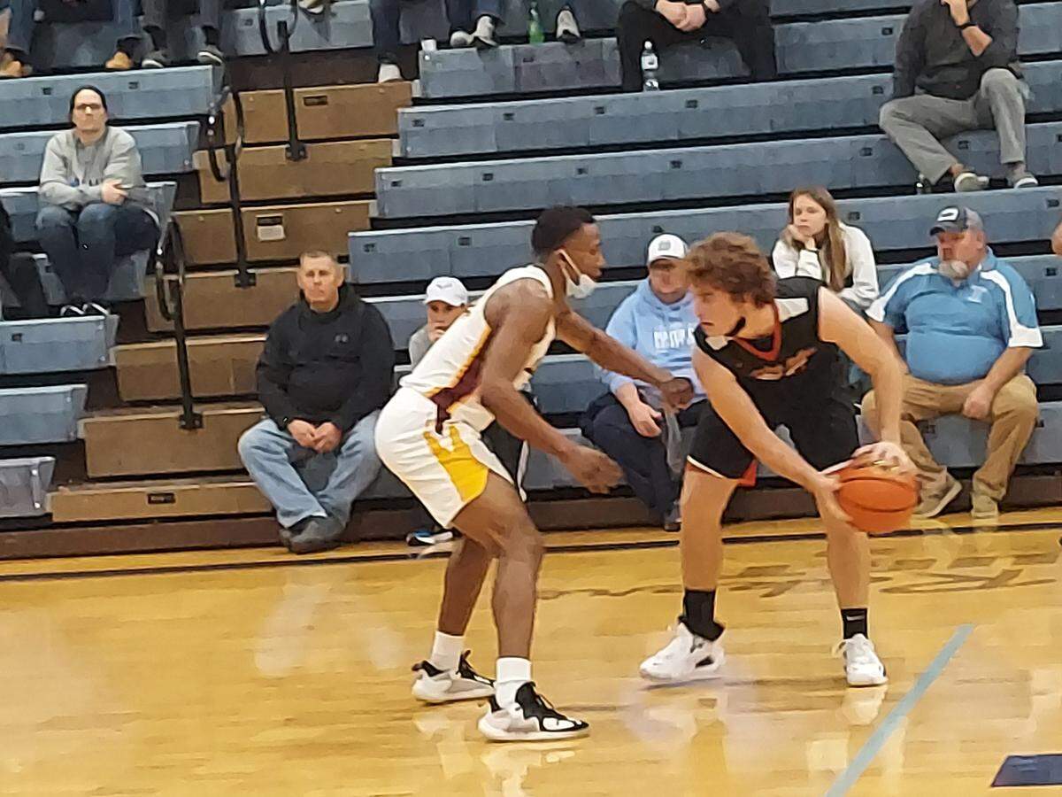 Highland’s Cade Altadonna looks to take Jeremiah Glover of Louisville Doss off the dribble during the Mater Dei Christmas Tournament on Wednesday, Dec. 29. The Bulldogs ultimately fell to Doss 69-38.