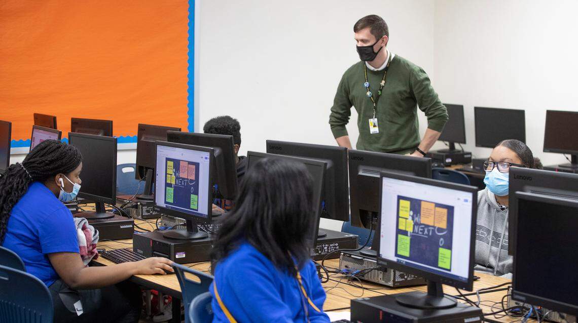 Josh Cummins, math department head and computer science teacher at East St. Louis Senior High School, works with students.