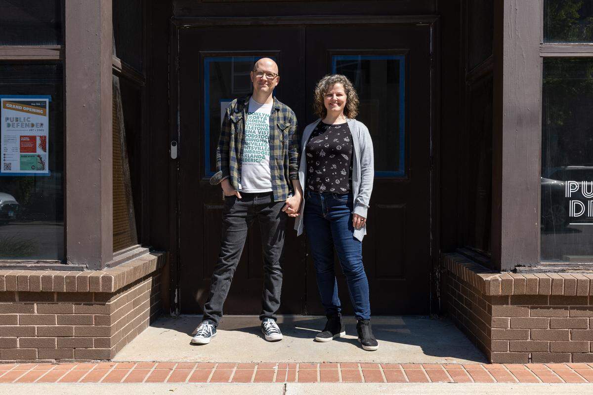 Danny Houk and Stacie Spaunhorst, the owners of Public Defender Art + Zines, which is set to open May 15, pose in front of their building at 123 W. Main St. in Belleville.