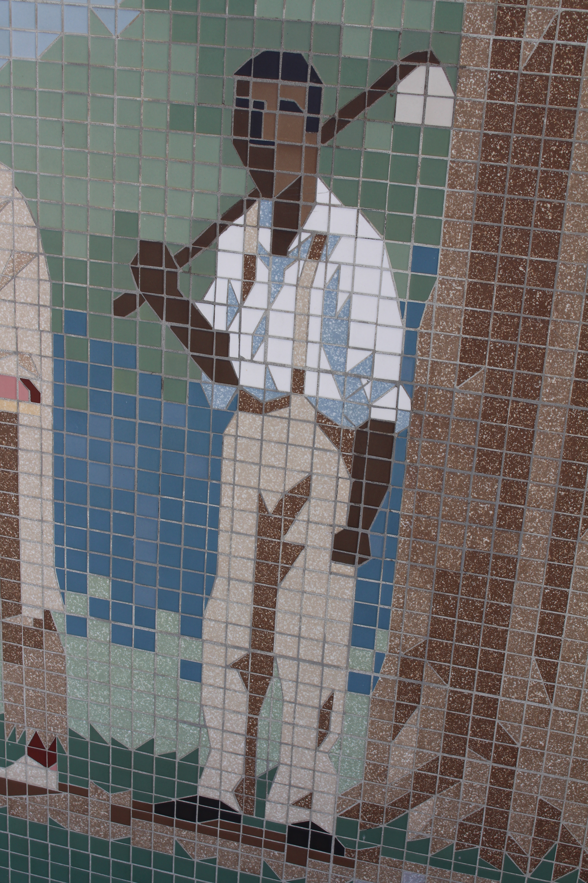 This detail of a mural on the old Edwardsville City Hall shows the altered black figure, who went from being a freed slave to a farmer with a garden hoe slung over his shoulder.