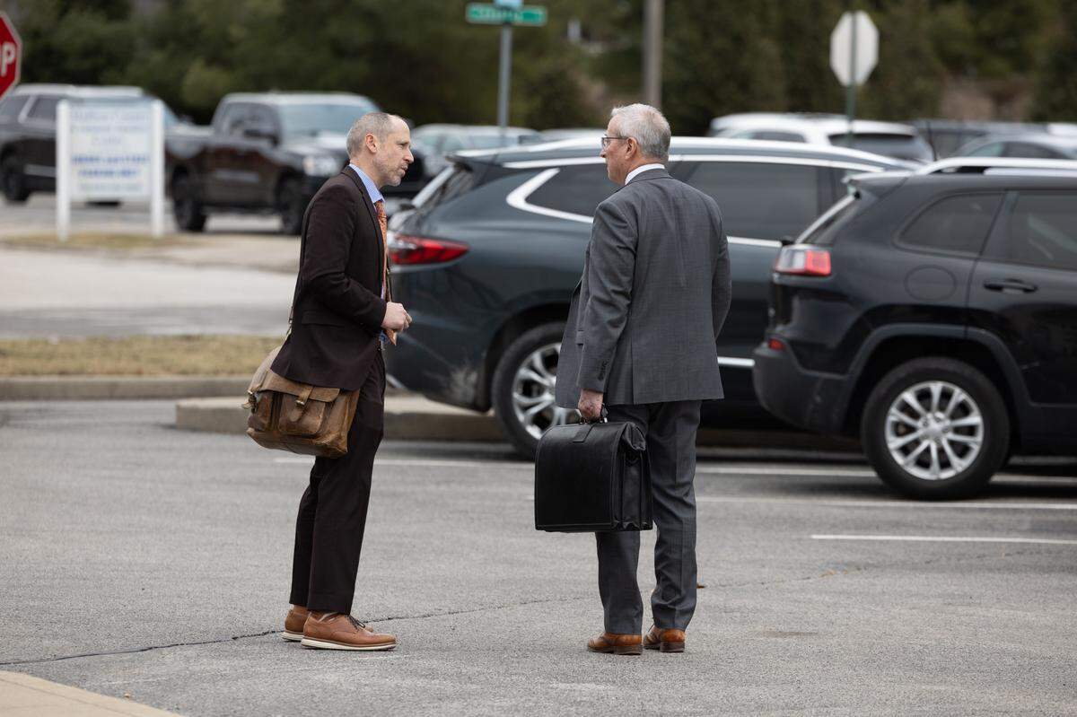 Jeremy Sackett, left, and David Fahrenkamp, defense attorneys for Neil Howard, talk outside of the Madison County Criminal Justice Center on Friday, the last day of testimony in Howard’s murder trial.
