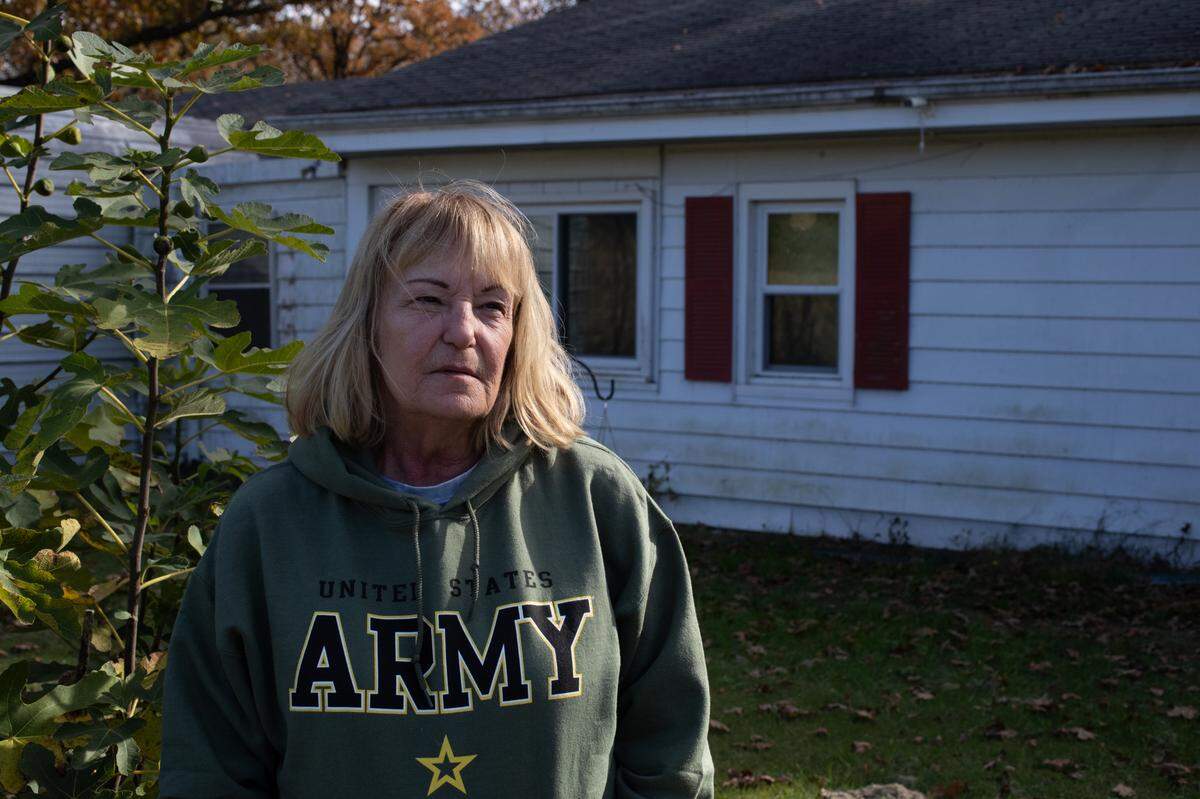 Lisa Rhodes is shown in front of a two-bedroom ranch home she bought about 20 years ago on land leased from George E. Hilgard American Legion Post 58 in rural Freeburg.