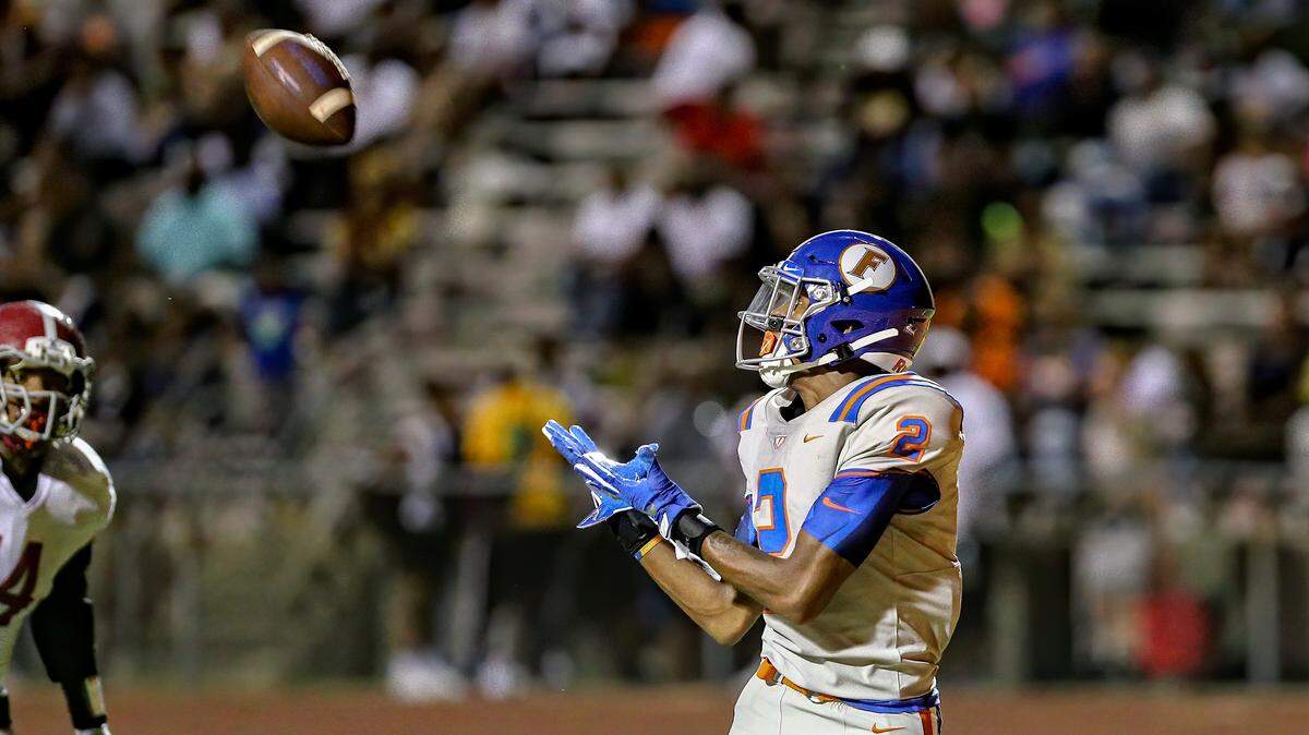 East St. Louis’ Antonio Johnson makes the catch in the end zone for the touchdown in a Flyers’ win Saturday.