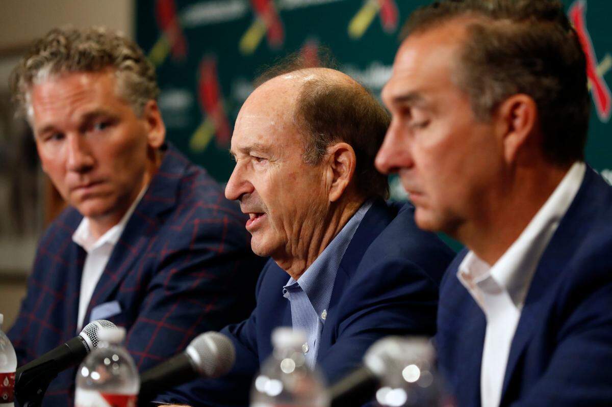 St. Louis Cardinals Bill DeWitt Jr., center, speaks as general manager Michael Girsch, left, and president of baseball operations John Mozeliak, right, listen prior to a game in 2018. On Friday afternoon, the organization agreed to a two-year, $5.5 million contract with right-handed pitcher Drew VerHagen.