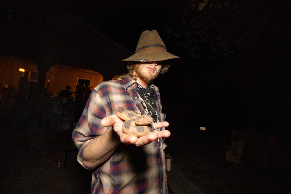 An attendee at the Nunnery holds out a fake snake he brought to the show. “I’ve been trying to scare people with this all night,” the patron confessed, “but no one’s fallen for it.”