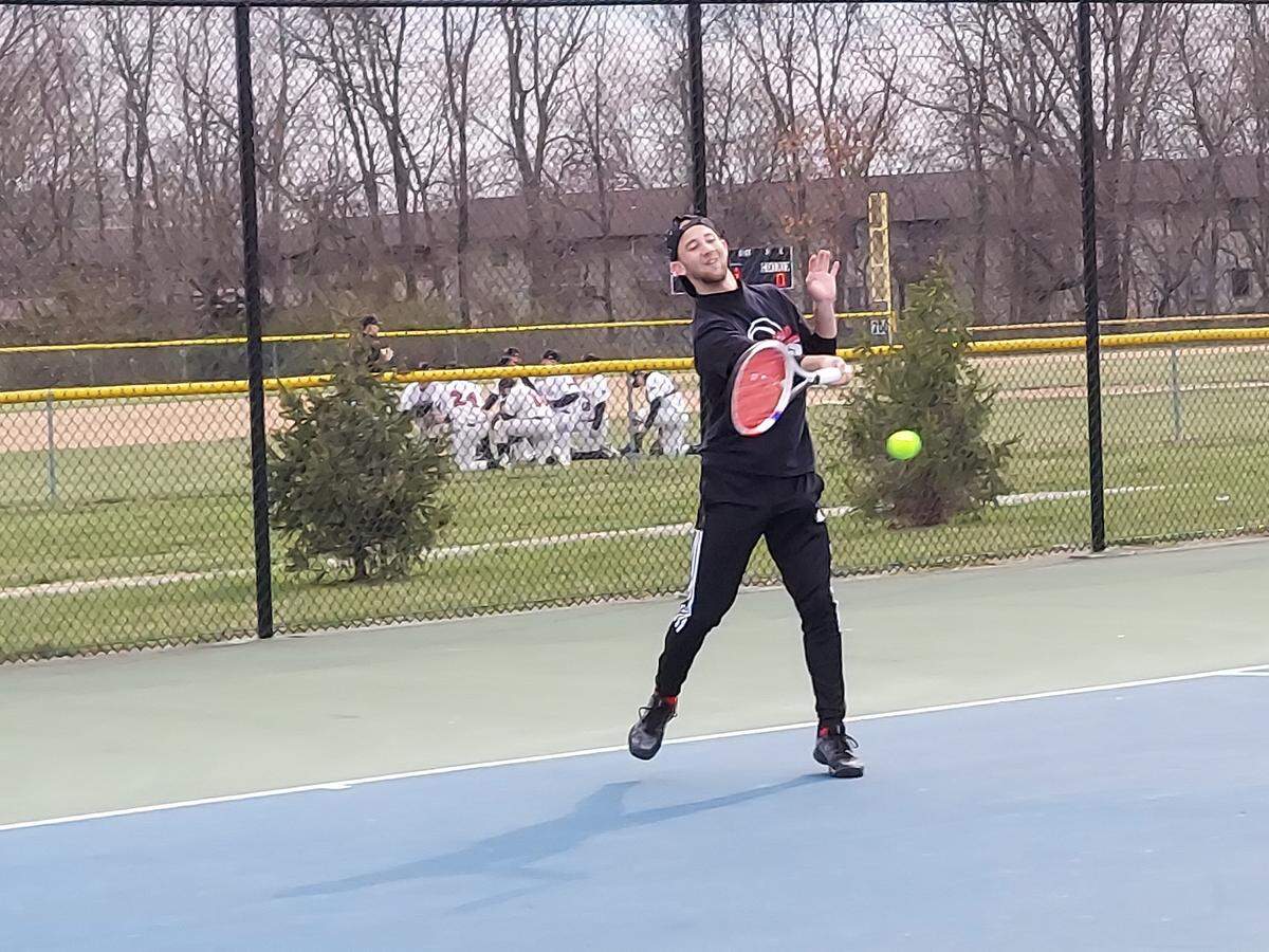 Highland senior Alex Roach returns a forehand shot during his No. 2 singles match against Belleville West earlier this season. On Thursday, April 14, Roach won his match at No. 2 singles against Mascoutah, but the Bulldogs ultimately dropped a 6-3 decision to the host Indians.