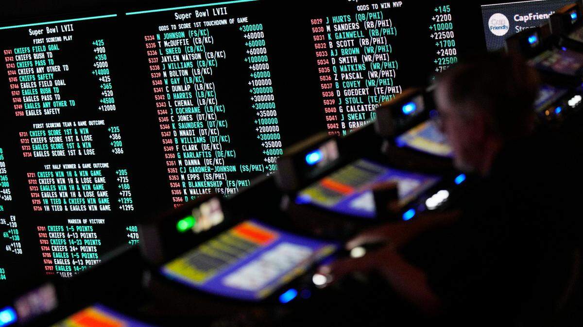 A person gambles as betting odds for NFL football’s Super Bowl are displayed on monitors at the Circa resort and casino sports book Friday, Feb. 3, 2023, in Las Vegas. (AP Photo/John Locher)
