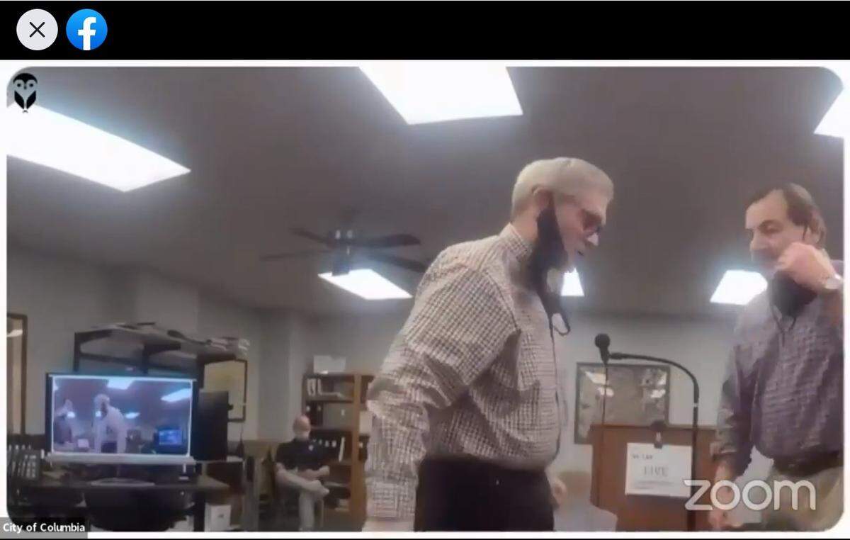 Former Columbia Ward 3 Alderman Gene Ebersohl, right, is shown replacing his mask after being sworn in as acting mayor by City Clerk Wesley Hoeffkin on Wednesday night at a special meeting streamed live on Facebook. .