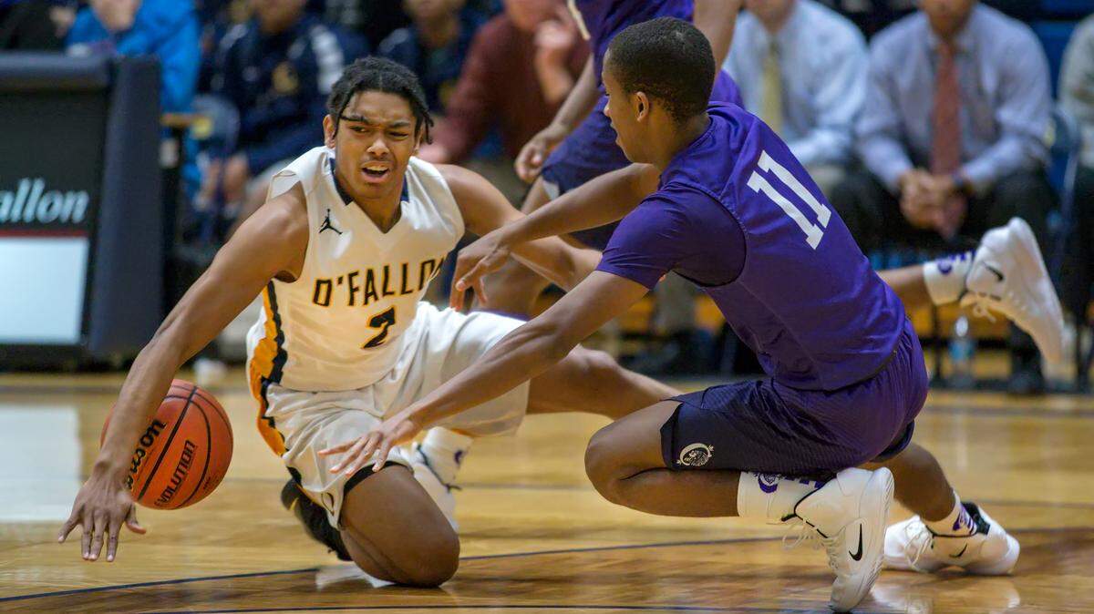  O’Fallon Quinn Harris  and Collinsville Cawhan Smith battle for the ball during Friday’s s conference game at O’Fallon High School.