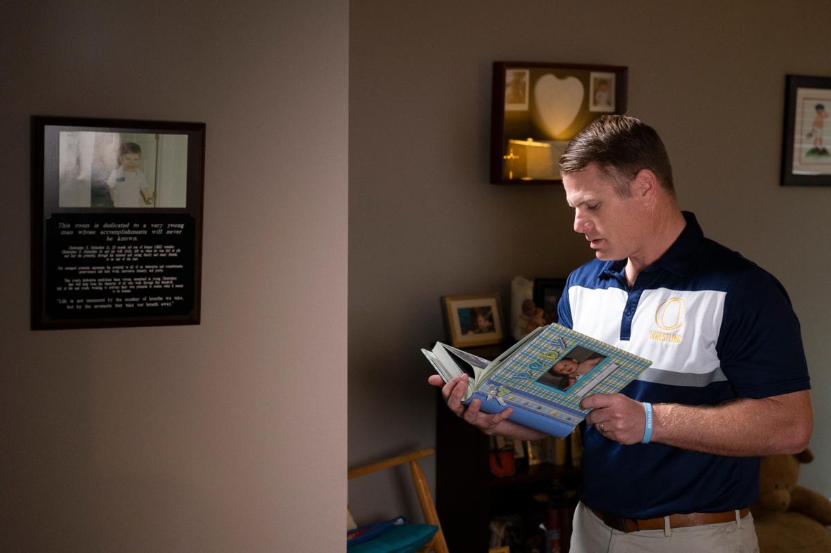 Christopher Schlachter Sr., looks through photo books in a room dedicated to the memory of his son, Christopher Schlachter Jr., in O’Fallon. In order to carry on his legacy, Schlachter Sr. started the Christopher Jr. Legacy for Drowning Prevention program in 2016 in partnership with the YMCA in O’Fallon and since its inception, the program have provided swimming lessons and educated over a thousand families on proper water safety and prevention.