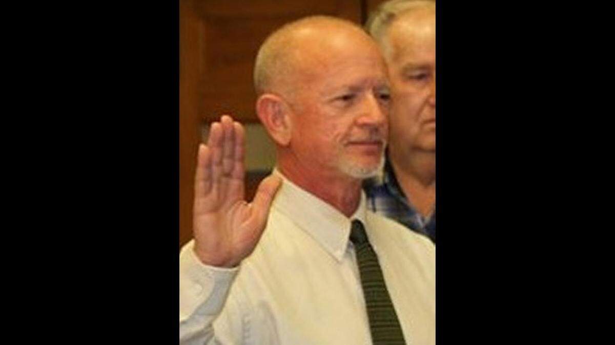 Troy Cannon, who began serving as Marion County deputy coroner in 2000 and became coroner in 2012, is shown taking the oath of office in an undated file photo. He left office last year.