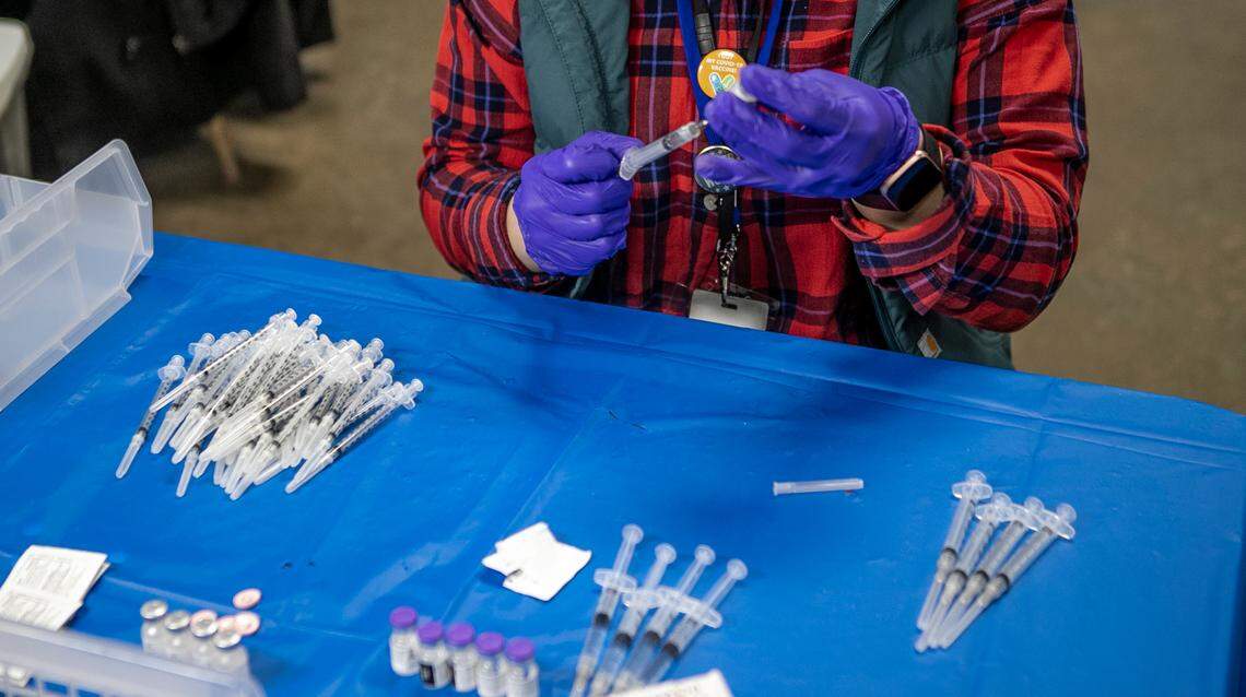 A healthcare professional prepares COVID-19 vaccination for use at the St. Clair County mass vaccination center in Belleville. In his latest piece, Belleville News-Democrat columnist Terry Mackin offers some tips for a post-COVID existence.
