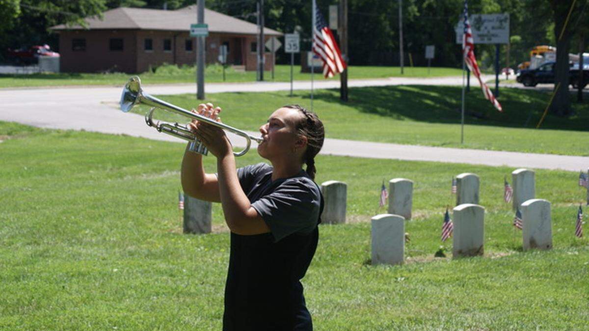 Belleville East High School senior Reese Brueggeman performs “Taps” during the Belleville Memorial Day Ceremony Monday morning at Walnut Hill Cemetery.