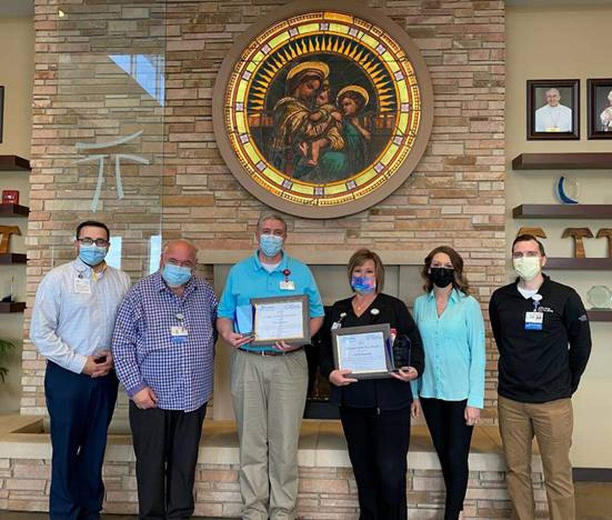 HSHS St. Joseph’s Hospital Highland named Tim Claxton, director of facilities (third from the left) Leader of the Year and Jill Helmkamp, imaging technologist (third from the right) Colleague of the Year. Both were recognized for their dedication to ensuring high-quality care and for exemplifying HSHS’ Core Values of Respect, Care, Competence and Joy. Pictured with Claxton and Helmkamp are Jed Driemeyer, director of human resources (far left); John Ludwig, president and CEO (second from left); Teresa Cornelius, chief nursing officer (second from right); and Mark Ennen, director of finance (far right). For more information about HSHS St. Joseph’s Hospital Highland, visit the hospital’s website at stjosephshighland.org.