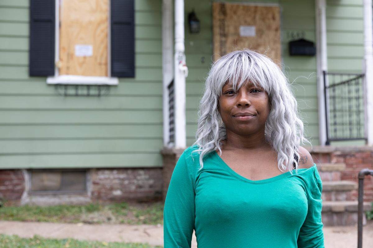 LaKia Mariconi, 44, stands in front of her North Church Street home on Friday. Belleville officials have declared it unfit for human occupancy because of code violations.