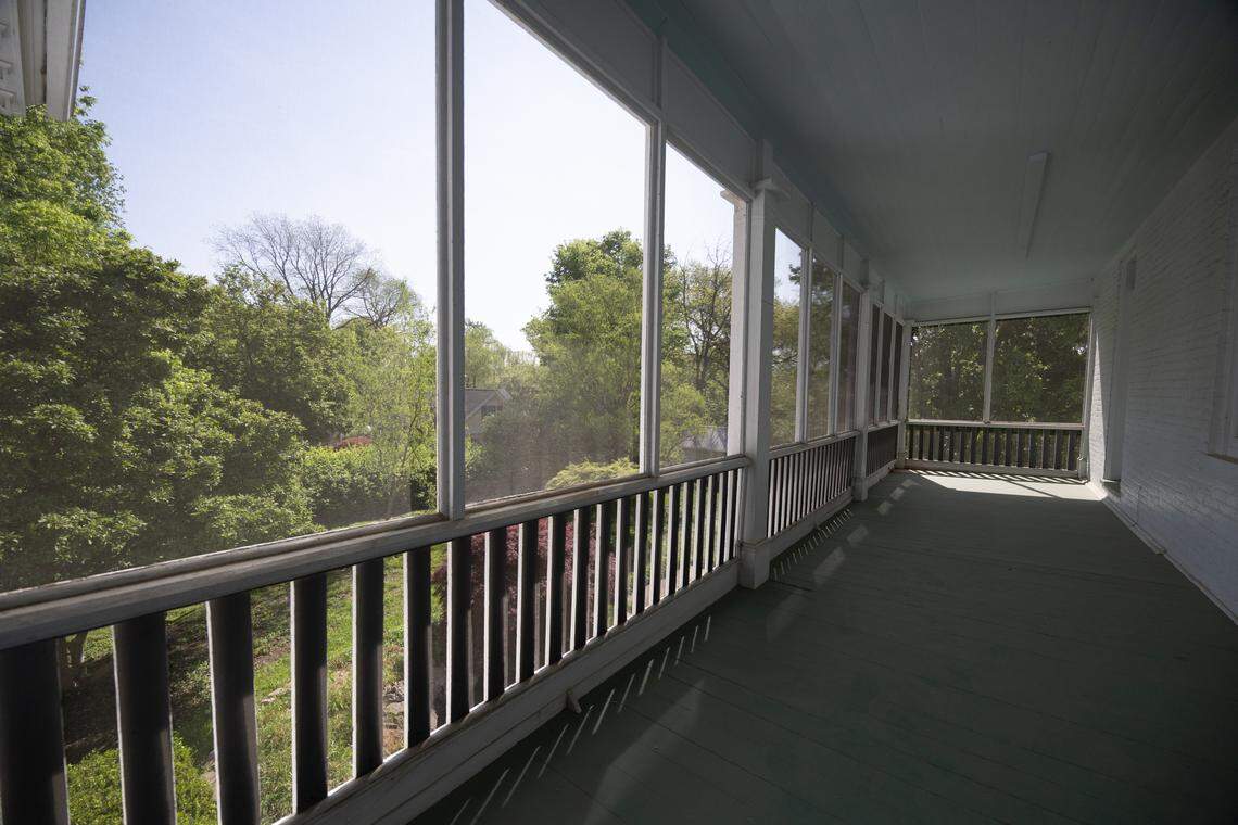 The second floor is home to a massive screened-in balcony, where the owner and guests can take in the serenity of the backyard garden below.