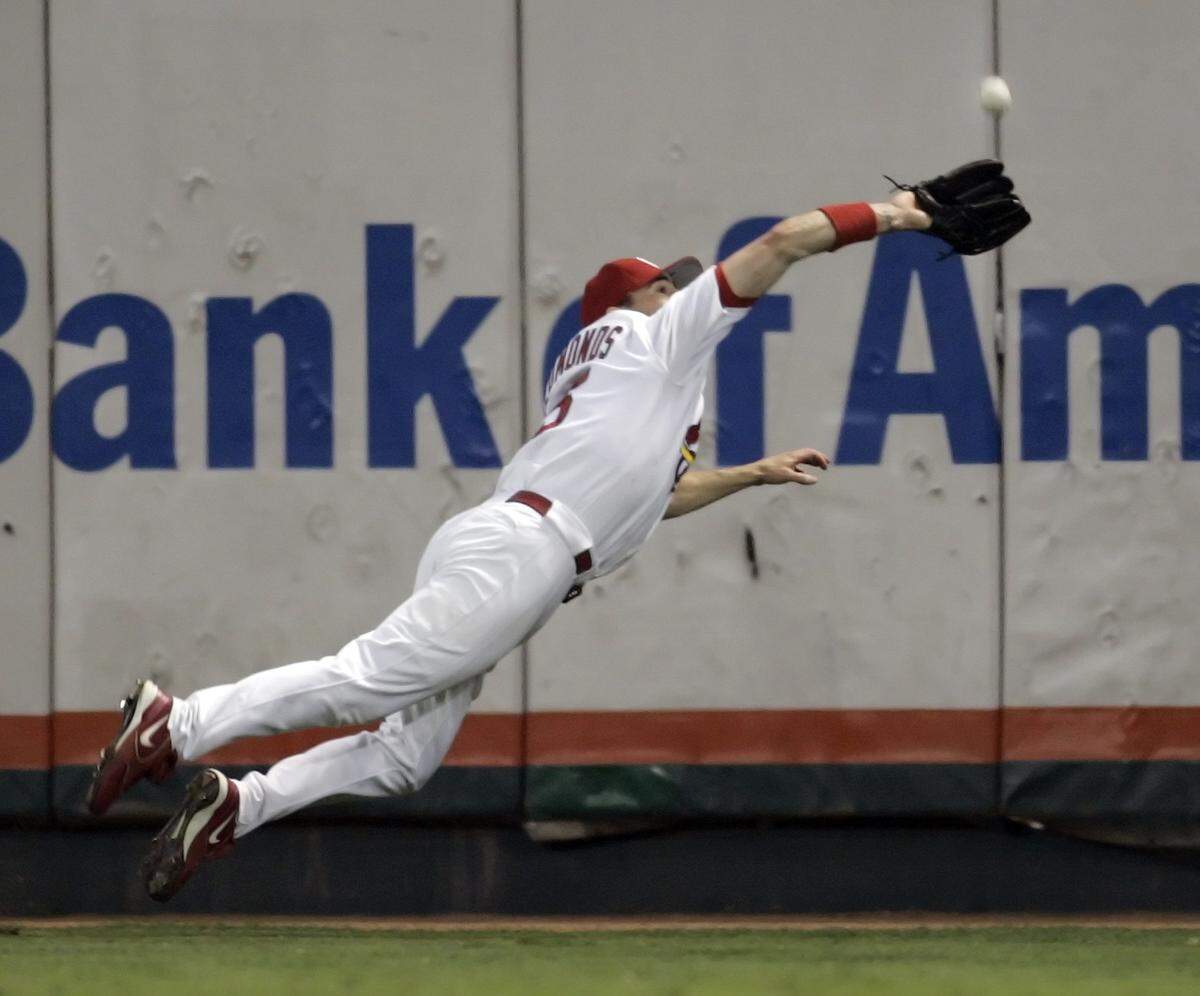 Jim Edmonds dives to catch a fly ball by Houston Astros’ Morgan Ensberg during the sixth inning in Game 2 of their National League Championship Series, Thursday, Oct. 13, 2005, in St. Louis. (AP Photo/Mark Humphrey)