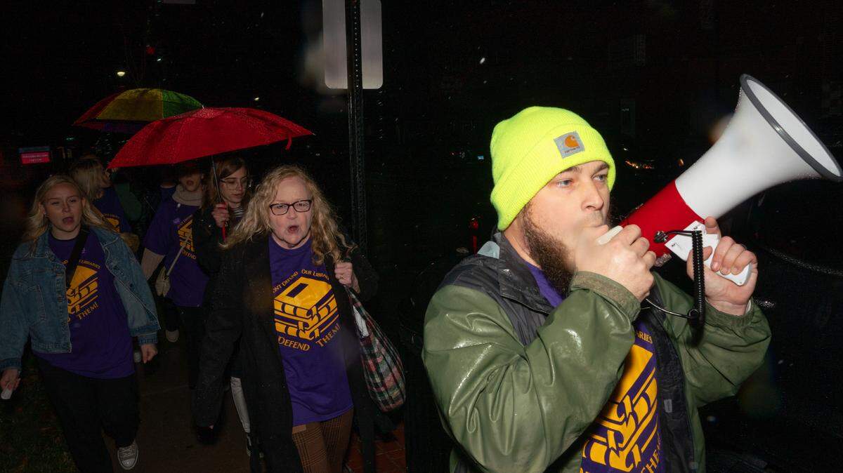 Protestors marched up and down Main St. while chanting “fund the library” prior to the public forum at the Collinsville, Ill. public library on Nov. 20, 2023.