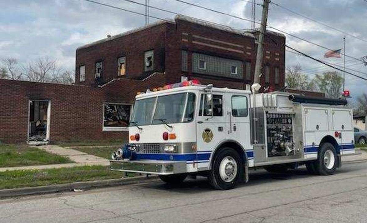 The Washington Park Fire Departments 1989 rescue truck, donated by the Elk Grove Fire Department in northeast Pennsylvania, is shown parked in front of the burned out remains of the village’s muncipal building.