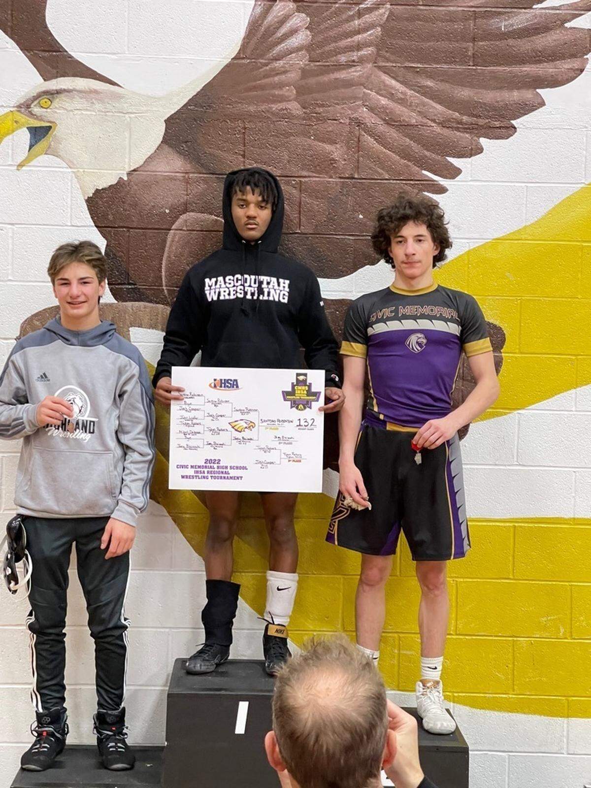 At 132 pounds, Highland’s Tyson Rakers, left, captured third place at the IHSA Class 2A regional at Civic Memorial High School on Saturday, Feb. 5, to advance to sectional competition. Pictured with Rakers are Santino Robinson of Mascoutah, top center, who captured first place, and Joey Biciocchi of Civic Memorial, right, who secured second place.