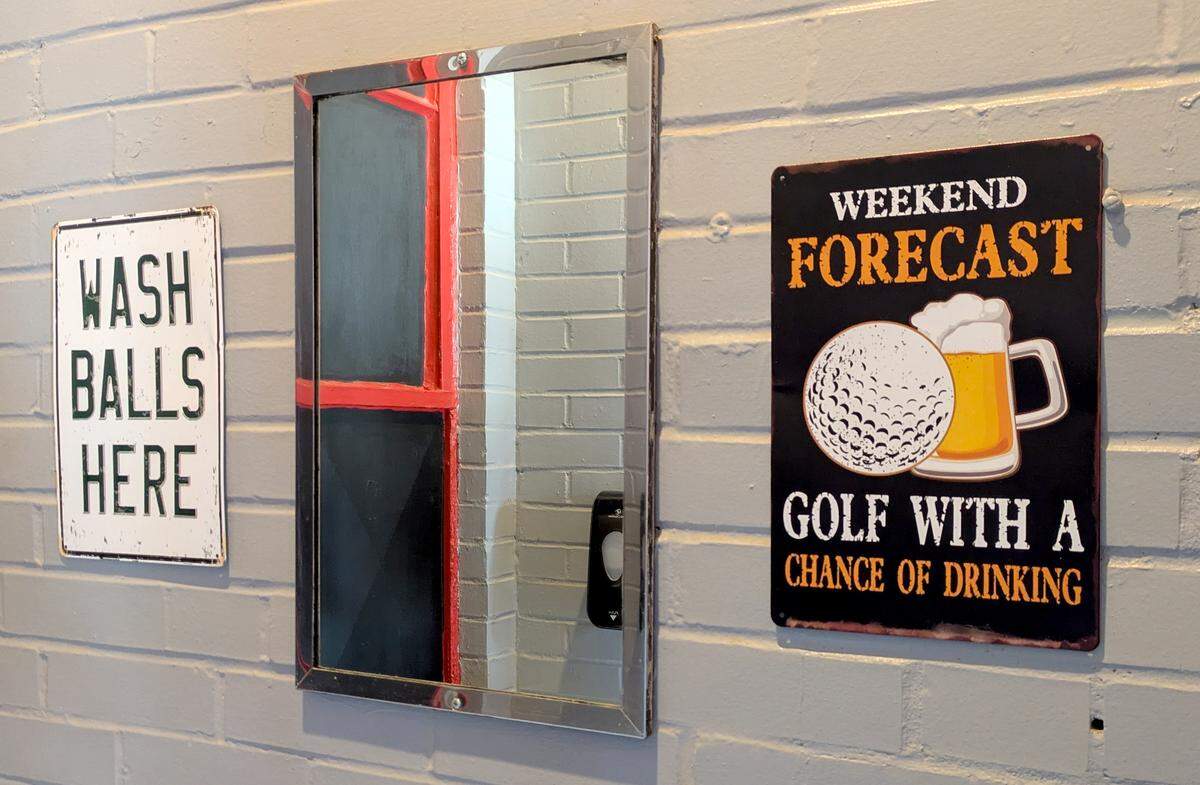 Signage in the men's restroom at The Golf Station in Granite City