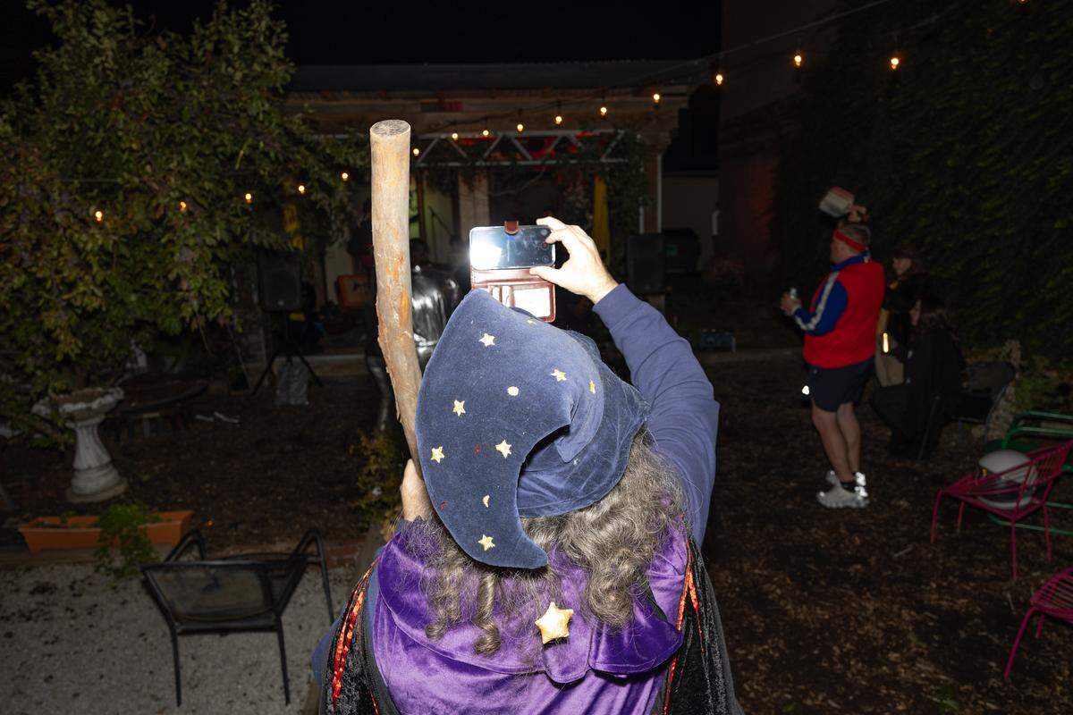 A person in a wizard costume records a performance at Spaces in downtown Belleville on Halloween.