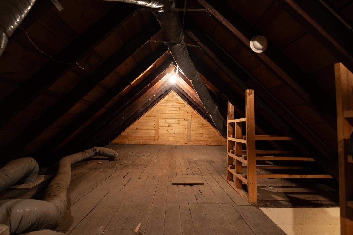 An attic on the top floor provides a unique storage space and evidence of historic architecture.
