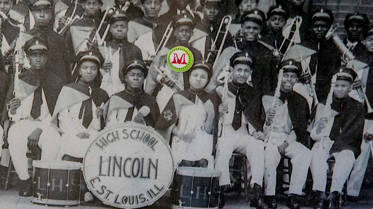 A photo of Miles Davis holding his trumpet in a band photo from Lincoln High School in East St. Louis on display at House of Miles ESTL.