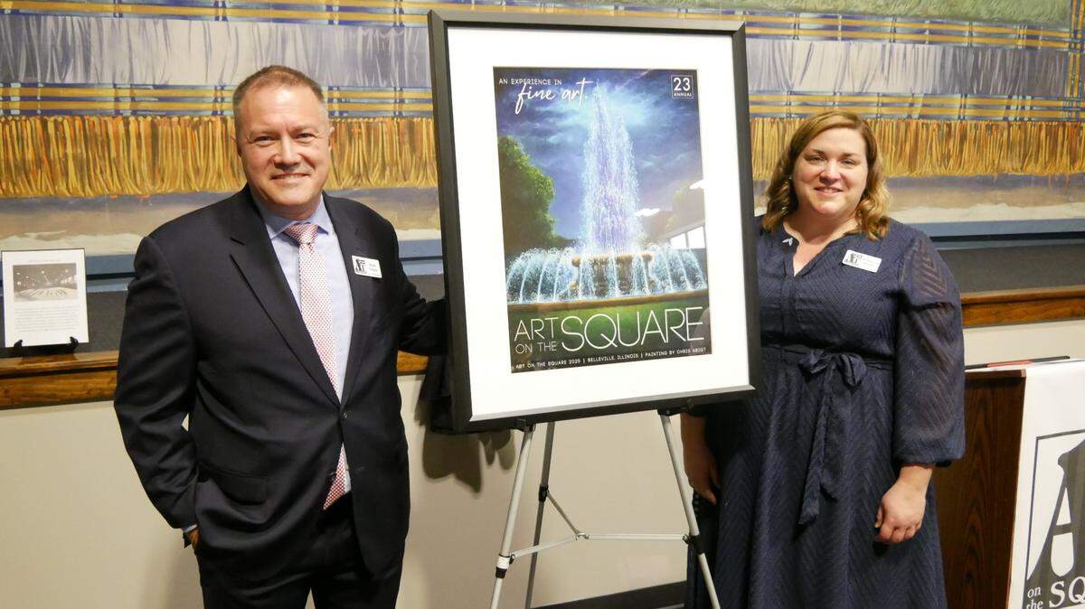 Karl Gilpin and Rebecca Boyer, co-directors of Art on the Square, unveil the 2025 commemorative poster, created by artist Chris Abigt. The art fair will be held Friday through Sunday in downtown Belleville.