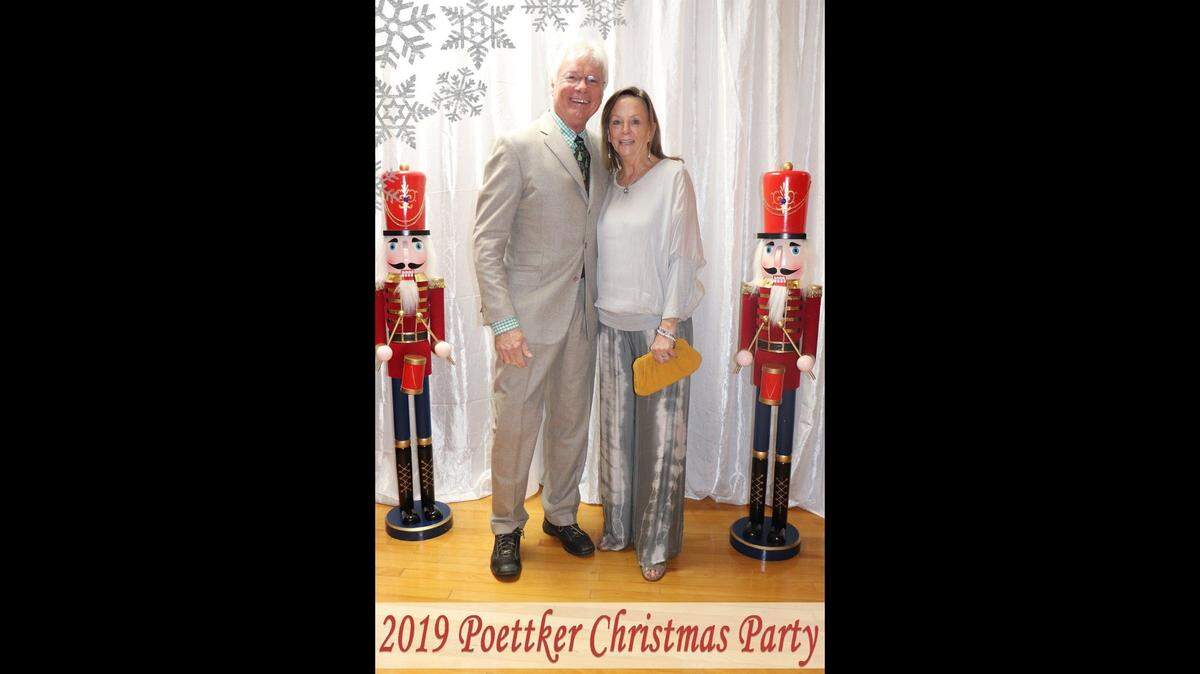 Charles “Chuck” Poettker and his wife, Linda, pose for a formal photo at the Poettker Construction Christmas party in 2019.