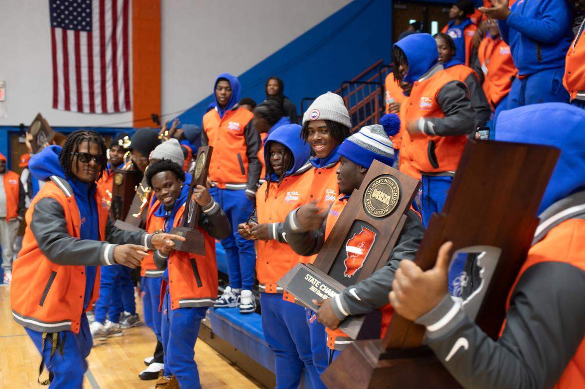 The Flyers celebrate their myriad football trophies prior to the victory parade through East St. Louis on Dec. 4, 2024.