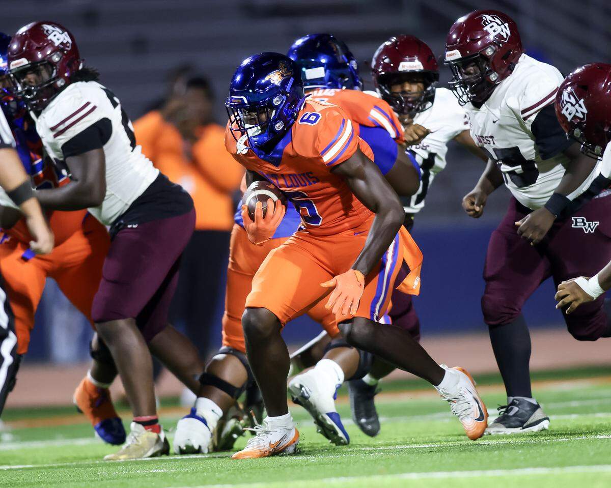 East St. Louis running back Myson Johnson-Cook carries against Belleville West Friday.